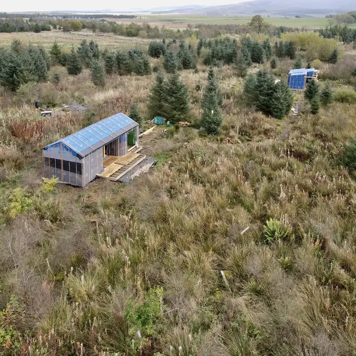 off-grid log cabin on ground screw foundations
